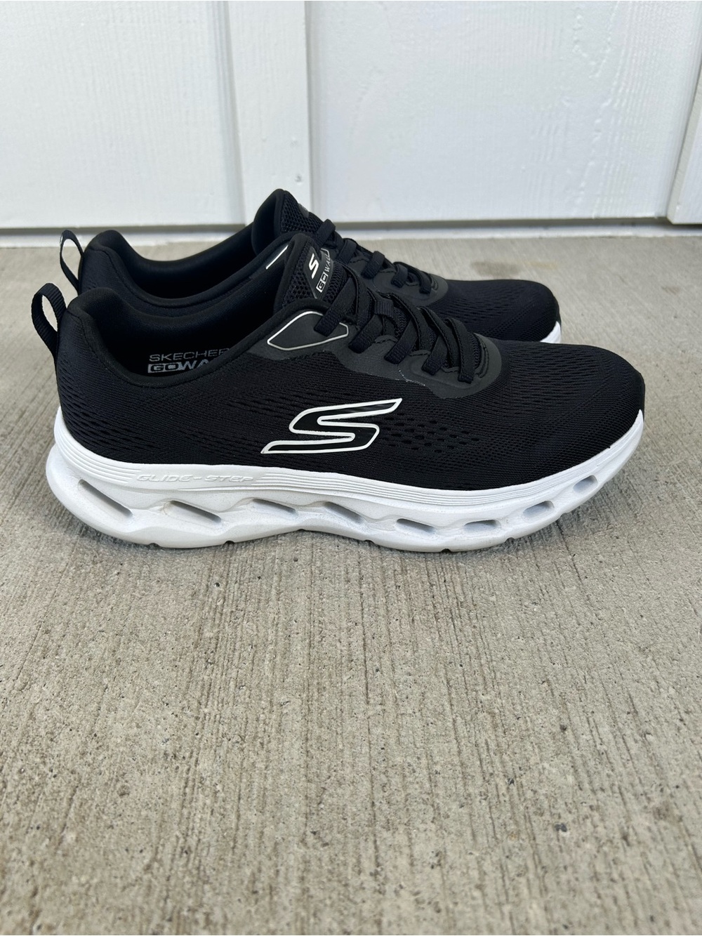 Skechers Black with White Sole Lightweight Slip-On Sneakers